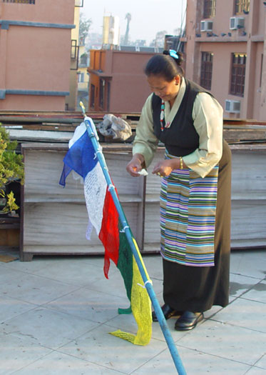 Pema preparing the new prayer flag.